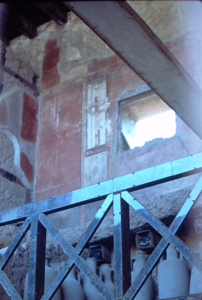 V.6 Herculaneum, 7th August 1976. Upper floor at north end of east side of shop.
Photo courtesy of Rick Bauer, from Dr George Fay’s slides collection.